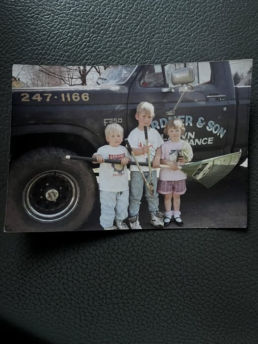 Three third-generation Gardner children standing with lawn-care tools in front of the family’s original Gardner and Son truck